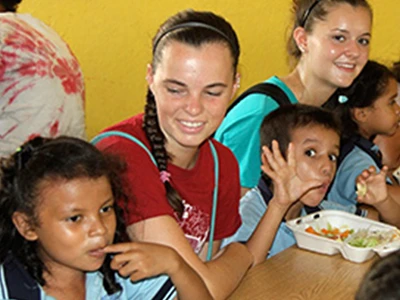 Female Student Eating With Kids Female Student Eating With Kids