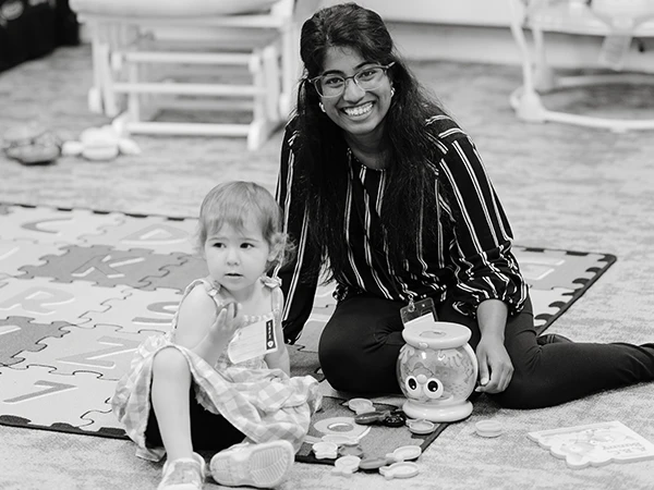 Woman with child playing on floor
