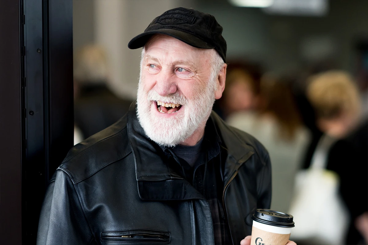 Women helping children at a registration table.