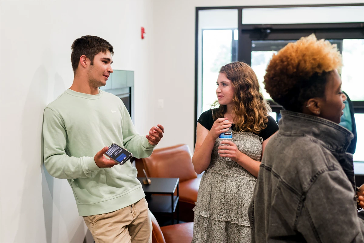Women helping children at a registration table.
